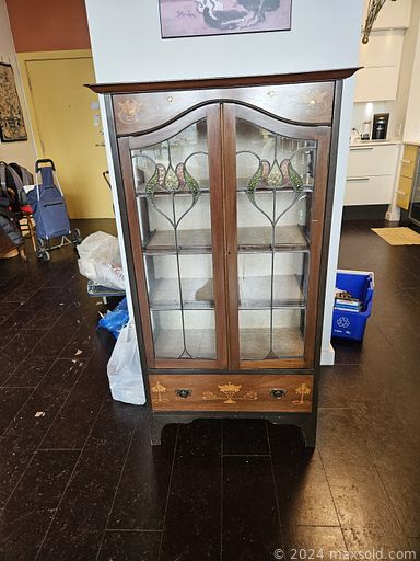 MaxSold Auction: This online auction includes books, end table, planter, sliding lounger, kitchenware, copper items, DVDs, duck storage box, pottery, mirror, lamp, rugs, metal shelf, wood servingware, desk, sofa, Art Nouveau bookcase and much more!