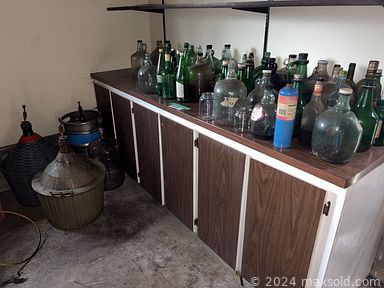 MaxSold Auction: This online auction features outdoor concrete table, bottles, furniture such as dresser, dining table, sofa and much more!