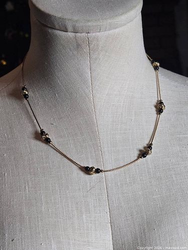 Jewelry.  Thin gold tone chain with black / gold embellishments (1 of 5)