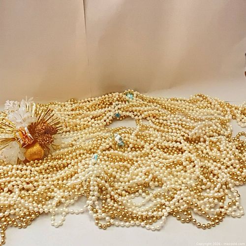 Many strands of gold and white beads. (1 of 1)