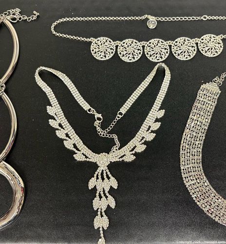 variety of silver-toned fashion jewelry, ranging from statement necklaces and chokers (1 of 13)