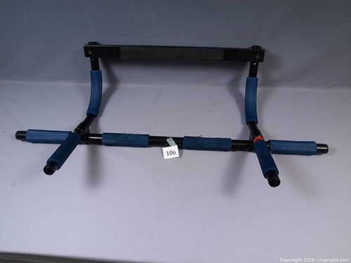 A doorway pull-up bar, used for strength training at home.  (1 of 3)