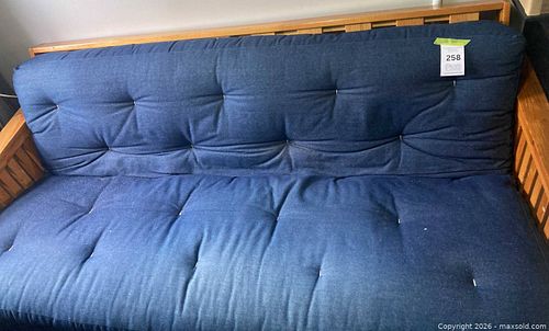 wooden-framed futon with a blue tufted mattress (1 of 7)