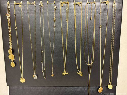 curated jewelry collection featuring a variety of minimalist and layered gold-tone chains (1 of 20)