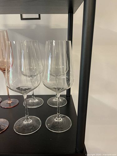 Elegant crystal wine glasses in a set of four. These glasses have a modern, angular bowl shape and thin stems. (1 of 1)
