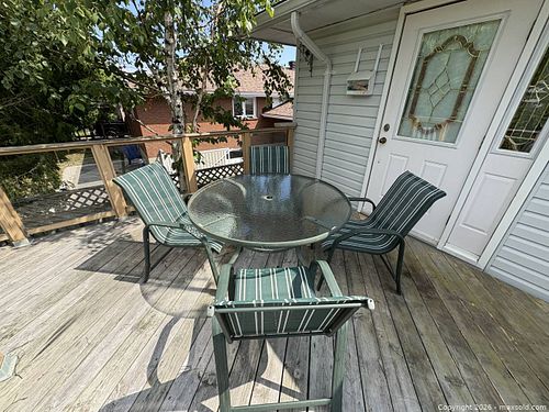 Green Patio Dining Set with Round Glass Table & 4 Sling Chairs (1 of 5)