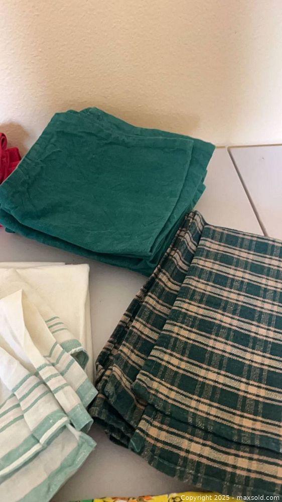 Assorted cloth napkins and red tablecloth | Maxsold