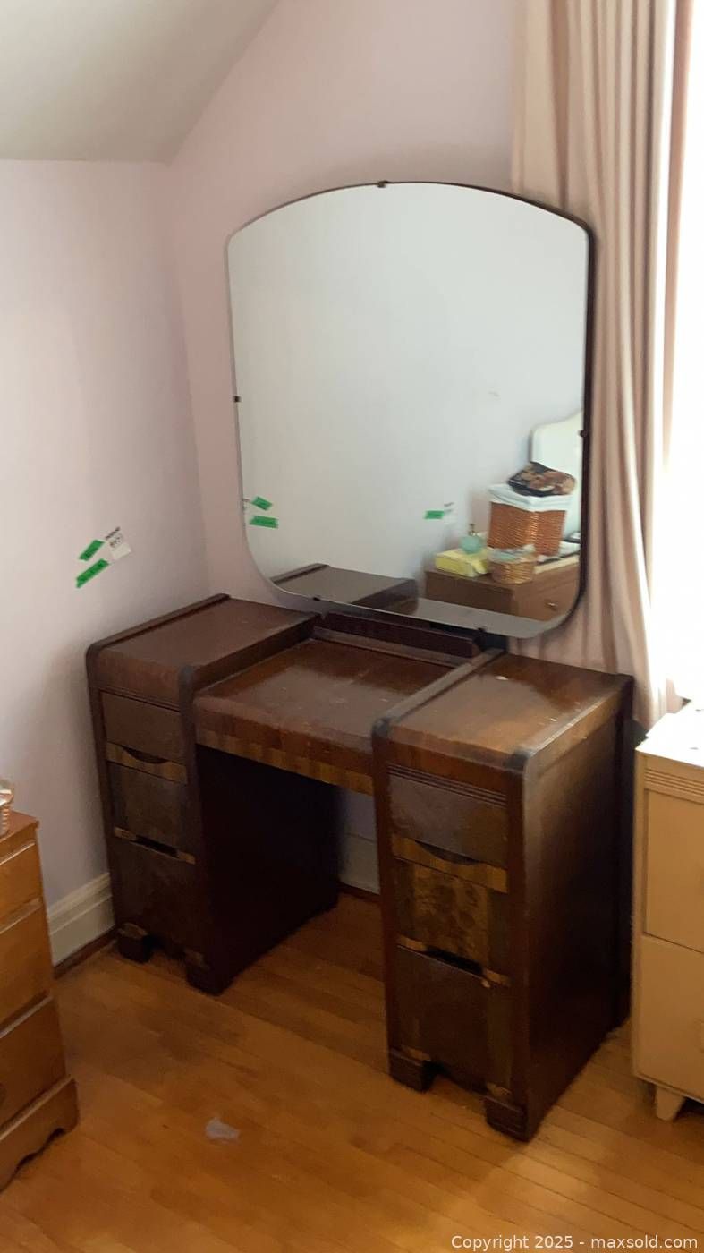 View of Art Deco waterfall vanity with attached mirror | Maxsold