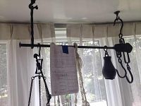 Photo of the vintage hanging metal scale showing its full width and hanging pan on beaded chain.