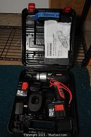 Photo showing Craftsman cordless drill, battery, charger, manual in black carrying case with red latches.