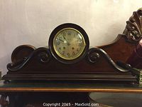 Front view of mahogany mantel shelf clock on display
