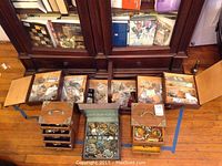 Overview of three wooden boxes and one green jewelry box with jewelry pieces