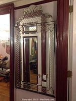 Full view of the mirror hanging on wall, showing overall shape, frame and shelf