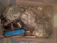 Plastic bin containing multiple sterling silver belt buckles and loose items