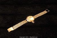 Full view of Waltham pocket watch with attached gold link band on black background