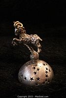 Front view of ram figurine mounted on dome base with star perforations