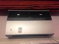 Front view of Friedrich air conditioning unit installed under window valance