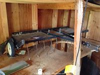 Tow dethatcher with metal tines, visible wear and rust, width about 48 inches.