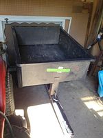 Front side view of the steel trailer attachment showing the cargo bed and the tow hitch