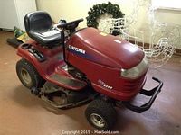 Side view of red Craftsman DYT4000 riding lawn tractor showing seat, steering and deck