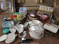 Wide view showing Pyrex chip and dip set, assorted bowls, CorningWare casserole, various pitchers, containers, and kitchen utensils.