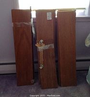 Several medium brown rectangular wooden shelves stacked vertically showing size and finish.