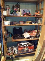 Wide view showing shelves stocked with boxed power tools including Wagner PowerCaulk 720, many hand tools, and the boxed Craftsman high pressure washer.