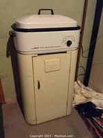 Full view of Nesco roaster on Westinghouse cabinet, showing condition and wear