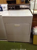 Full view of the white Kenmore electric dryer showing front door and control panel.