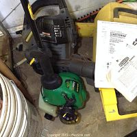 Photo showing Craftsman leaf blower and WeedEater FeatherLite trimmer on floor, with some manuals visible