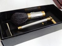Photo of the shaving brush and safety razor placed inside the black box.