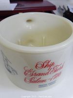 Off-white ceramic shaving mug with red script text 'Ship Strand Turk Salem 1786' and blue manufacturer text 'Shulton Company Toronto, Canada'. Shows the outer surface and design details.