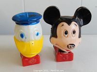 Photo of Donald Duck and Mickey Mouse character head night lights, front and slightly angled view showing both figures together.
