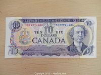 Front view of 1971 Canadian ten-dollar bill showing serial number, portrait, and denomination.