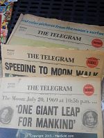 Three stacked newspapers with visible headlines referencing the moon landing in July 1969 from The Telegram.