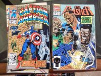 Stack of Captain America and The Punisher comics showing colorful cover art with character action poses. Includes Captain America issue 397 and The Punisher issue 6.1.
