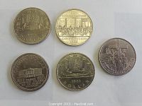 Top view of all five Canadian dollar coins showing front designs and inscriptions.