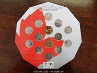 Photo of the 2010 Vancouver Olympic Coin Set displayed on the themed card featuring Canadian red maple leaf background and arranged coins.