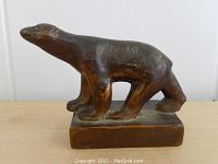 Front and side view of bronze polar bear paperweight showing naturalistic form and wear on patina.