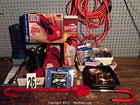 Image showing Dirt Devil vacuum cleaner with box, copper pipe connectors, fire extinguisher, orange extension cord, vacuum bags and hardware parts