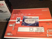 Photo showing the original box for Hitachi DV-RF7U DVD/VHS recorder with a sealed coaxial video cable on top.