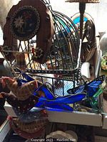 Photo showing stained glass birds, metal wire cage, and fabric embroidered birds arranged together