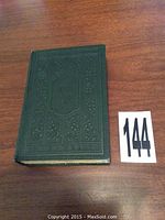Front cover of Kipps book showing blindstamped green cloth with floral design and embossed title.