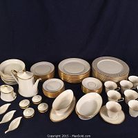 Wide view of most items including stacks of plates, teapot, sugar bowl, shakers, leaf salt dishes and cups.