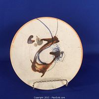 Top view of signed porcelain footed bowl showing abstract brushstroke interior design and crackled glaze.