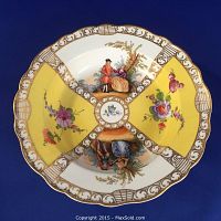 Overhead view showing bowl’s four quadrants: two with courting couple scene and two yellow floral panels, gilt scroll border.