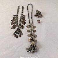 Full view of the jewelry lot showing necklace, coin necklace, earrings, brooch, and ring.