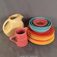 Overall view of 13-piece set with pitchers, plates and bowls arranged