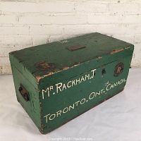 Overall view of green painted pine chest showing hand-painted markings and hardware