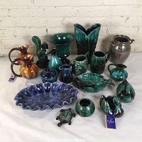 Overview of 16 assorted Blue Mountain Pottery pieces including vases, pitchers, jar, platter and figurine.